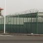 FILE - In this Monday, Dec. 3, 2018, file photo, a guard tower and barbed wire fence surround a detention facility in the Kunshan Industrial Park in Artux in western China&#39;s Xinjiang region. The Associated Press has found that the Chinese government is carrying out a birth control program aimed at Uighurs, Kazakhs and other largely Muslim minorities in Xinjiang, even as some of the country&#39;s Han majority is encouraged to have more children. The measures include detention in prisons and camps, such as this facility in Artux, as punishment for having too many children. (AP Photo/Ng Han Guan, File)