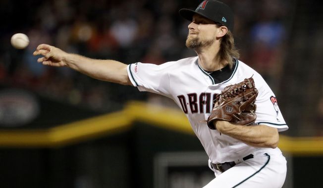 FILE - In this Sept. 24, 2019, file photo, Arizona Diamondbacks starting pitcher Mike Leake throws against the St. Louis Cardinals during the first inning of a baseball game, in Phoenix. Diamondbacks right-hander Mike Leake has opted out of the 2020 season due to concerns about the coronavirus. Diamondbacks general manager Mike Hazen did not elaborate on Leake’s decision during a Zoom call, but the pitcher’s agent issued a statement saying he made a personal decision not to play during the pandemic. (AP Photo/Matt York, File)