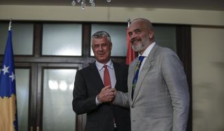 Kosovo president Hashim Thaci shakes hands with Albania Prime Minister Edi Rama during his official visit to Kosovo in Pristina, Monday, June 29, 2020. Kosovo’s president on Monday denied committing war crimes during and after a 1998-1999 armed conflict between ethnic Albanian separatists and Serbia and said he would resign if the indictment is confirmed by an international war crimes court. (AP Photo/Visar Kryeziu)