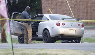 Officers investigate the scene of a shooting where two Tulsa Police Officers were shot Monday, June 29, 2020, in in Tulsa, Okla. (Mike Simons/Tulsa World via AP)