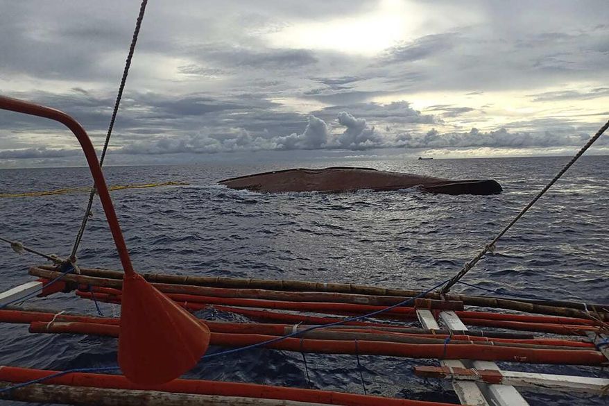 This June 28, 2020, photo provided by the Philippine Coast Guard, shows the remains of the FV Liberty 5 along the waters off Mamburao town in Mindoro Occidental province, south of Manila, Philippines. The Philippine coast guard was searching on Monday for 14 people missing since a fishing boat and cargo vessel collided in choppy waters two nights earlier. (Philippine Coast Guard via AP)