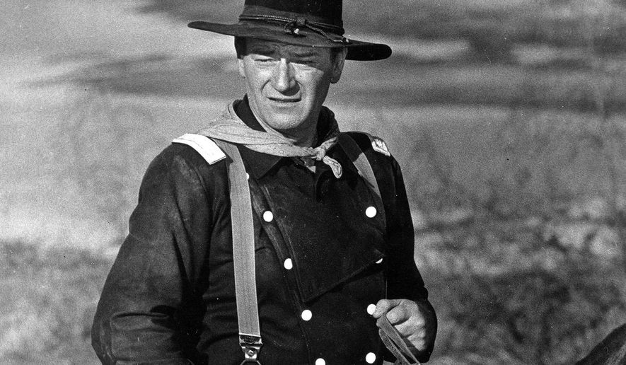 FILE - In this undated photo, John Wayne appears during the filming of &amp;quot;The Horse Soldiers.&amp;quot; In the latest move to change place names in light of U.S. racial history, leaders of Orange County’s Democratic Party are pushing to drop film legend Wayne’s name, statue and other likenesses from the county’s airport because of his racist and bigoted comments. (AP Photo, File)