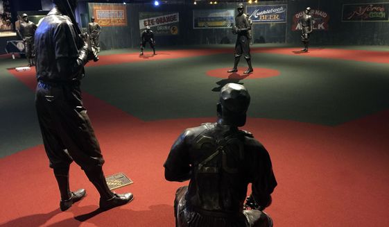 In this undated photo provided by the Negro Leagues Baseball Museum, the Field of Legends at the Negro Leagues Baseball Museum is viewed in Kansas City, Mo. The display features 10 life-size statues of Negro League greats cast in position as if they were playing a game. Former President Barack Obama tipped his cap. So did three other former presidents and a host of prominent civil rights leaders, entertainers and sports legends in a virtual salute to the 100-year anniversary of the founding of baseball’s Negro Leagues. The campaign launched Monday, June 29, 2020, with photos and videos from, among others, Hank Aaron, Rachel Robinson Derek Jeter, Colin Powell, Michael Jordan, Obama and presidents George W. Bush, Bill Clinton and Jimmy Carter at tippingyourcap.com. (Negro Leagues Baseball Museum via AP)