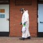 A worker for Leicester City Council disinfects public toilets in Leicester, England, Monday June 29, 2020. The central England city of Leicester is waiting to find out if lockdown restrictions will be extended as a result of a spike in coronavirus infections. (Joe Giddens/PA via AP)