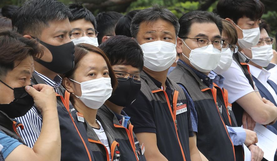 Financial union members wearing face masks to help protect against the spread of the new coronavirus attend a rally against government&#39;s financial policy in front of the Financial Supervisory Service in Seoul, Monday, June 29, 2020. (AP Photo/Ahn Young-joon)