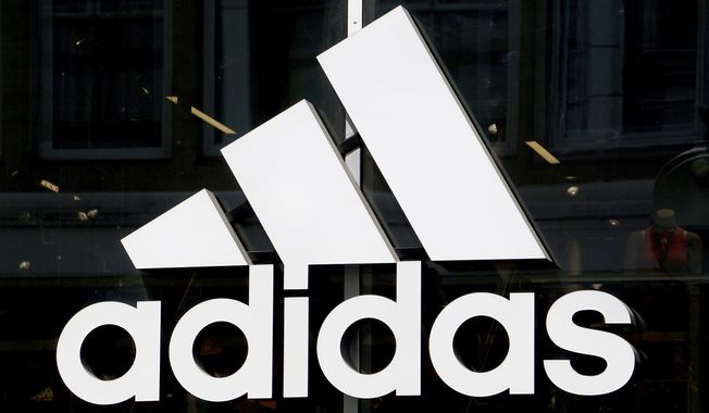 This May 6, 2019 photo shows the logo of the sports goods manufacturer Adidas in Berlin, Germany. The head of global human resources at sports apparel and shoe company Adidas resigned Tuesday, June 30, 2020 following criticism from employees of what they see as the company&#x27;s failure to diversify its workforce. (AP Photo/Michael Sohn)