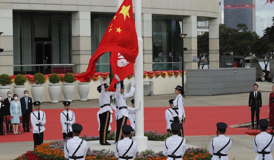 A flag raising ceremony is held at the Golden Bauhinia Square to mark the anniversary of the Hong Kong handover to China in Hong Kong, Wednesday, July 1, 2020. Hong Kong marked the 23rd anniversary of its handover to China in 1997, one day after China enacted a national security law that cracks down on protests in the territory.(AP Photo/Kin Cheung)