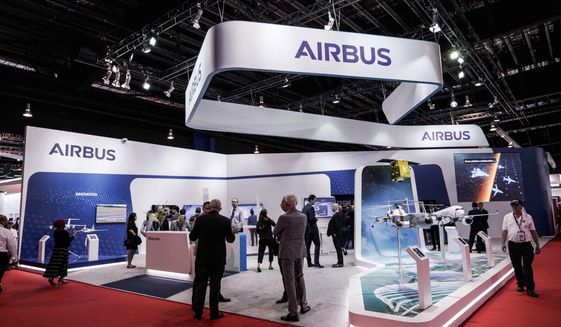 FILE - In this Tuesday, Feb. 11, 2020 file photo, visitors are seen at the booth of Airbus during the opening trade day of the Singapore Airshow 2020 in Singapore. European aircraft manufacturer Airbus says it plans to shed 15,000 jobs over the next year, with jobs mostly being lost in Europe. Airbus is struggling with the financial hit of the coronavirus pandemic. It said Tuesday, June 30 that it doesn&#39;t expect air traffic to recover to pre-COVID levels before 2023 and potentially as late as 2025. (AP Photo/Danial Hakim, file)