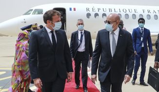 French President Emmanuel Macron, left, is welcomed by Mauritania President Mohamed Ould Ghazouani, right, upon arrival at Nouakchott Oumtounsy International Airport Tuesday June 30, 2020, in Nouakchott, to attend a G5 Sahel summit. Leaders from the five countries of West Africa&#x27;s Sahel region, Burkina Faso, Chad, Mali, Mauritania and Niger, meet with French President Emmanuel Macron and Spanish Prime Minister Pedro Sanchez in Mauritania&#x27;s capital Nouakchott on Tuesday to discuss military operations against Islamic extremists in the region, as jihadist attacks mount. The five African countries, known as the G5, have formed a joint military force that is working with France, which has thousands of troops to battle the extremists in the Sahel, the region south of the Sahara Desert. (Ludovic Marin, Pool via AP)