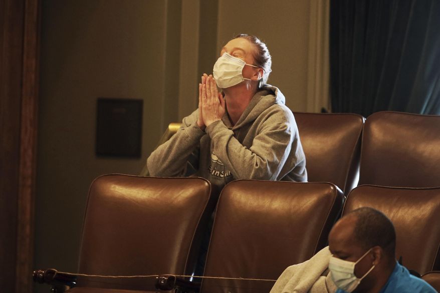 FILE - In this April 14, 2020 file photo, Nicole Smith-Holt reacts in the gallery after the Minnesota House passed a long-awaited insulin affordability bill championed by Smith-Holt,in St. Paul, Minn. Her 26-year-old son Alec, of Minneapolis, died of diabetic complications in 2017 because he was forced to ration his supply of the drug. Minnesota diabetics who need emergency insulin supplies but can't afford them will be able to get them starting Wednesday, July 1, 2020 under a new state law. (AP Photo/Jim Mone File)
