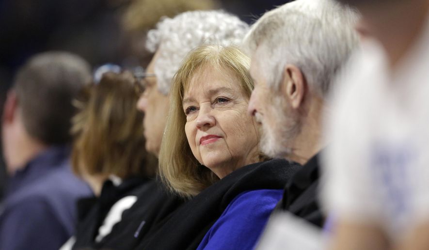 FILE - In this Nov. 17, 2019, file photo, St. Louis Mayor Lyda Krewson sits during an NCAA college basketball game between Saint Louis and Seton Hall in St. Louis. Krewson was elected on a pledge to address the violence that ravages her city. Amid that backdrop, it’s not surprising that calls to defund police don’t sit well with her. Yet Krewson’s decision to publicly reveal the names and addresses of anti-police protesters has put her among the big city mayors facing closer scrutiny in the racially charged weeks after George Floyd’s death. (AP Photo/Jeff Roberson, File)