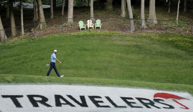 Dustin Johnson walks away from the 15th tee box after teeing off during the final round of the Travelers Championship golf tournament at TPC River Highlands, Sunday, June 28, 2020, in Cromwell, Conn. (AP Photo/Frank Franklin II)