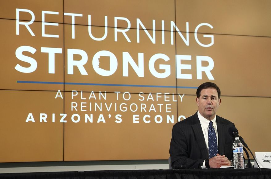 FILE - In this May 20, 2020, file photo, Arizona Gov. Doug Ducey speaks during a news conference in Phoenix to give the latest updates regarding the coronavirus. While the Republican governor has never discouraged the use of masks, his full-throated endorsement of them Monday, June 29, was a big change from a largely lukewarm stance the last few months. (AP Photo/Ross D. Franklin, Pool, File)