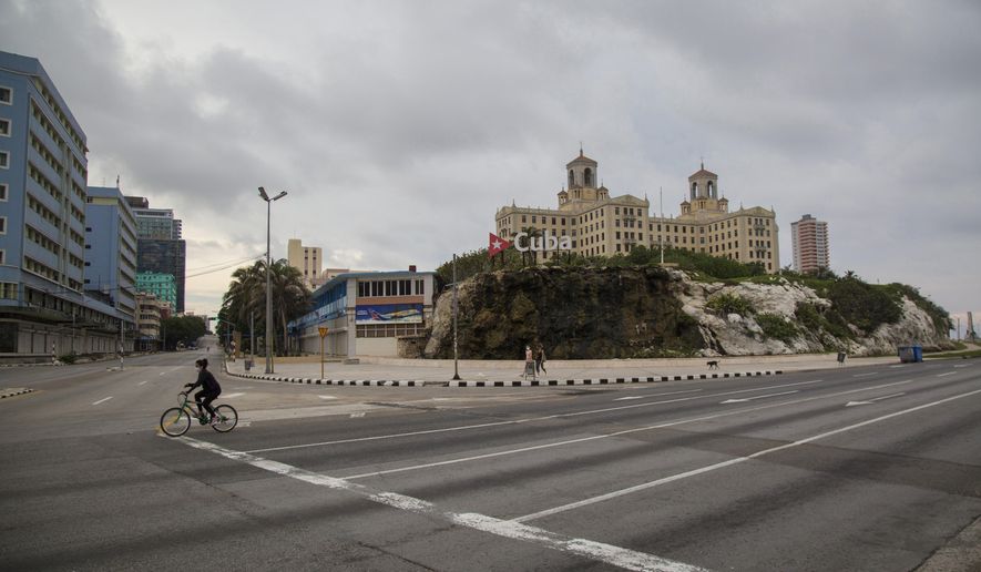 Hotel Nacional stands tall near the empty intersection of 23rd Street and the Malecon seawall, amid a lockdown to curb the spread of COVID-19 in Havana, Cuba, Saturday, June 20, 2020. Like other Caribbean islands, Cuba is highly dependent on tourism. It also earns hard currency from the export of medical and other professional services, remittances, and subsidized petroleum from Venezuela. (AP Photo/Ismael Francisco)