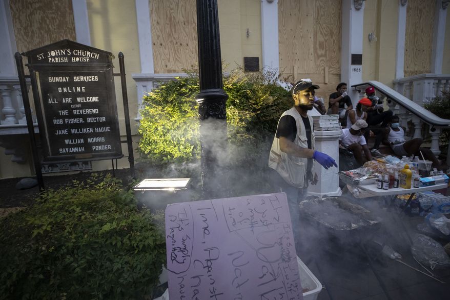 People set up tables and provide free food and drinks on the sidewalk in front of St. John&#x27;s Church as demonstrators protest Thursday, June 4, 2020, near the White House in Washington, over the death of George Floyd, a black man who was in police custody in Minneapolis. Floyd died after being restrained by Minneapolis police officers. (AP Photo/Alex Brandon)