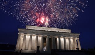 In this July 4, 2019, file photo, fireworks go off over the Lincoln Memorial in Washington. The Trump administration is promising one of the largest fireworks displays in recent memory for Washington on July 4. It also plans to give away as many as 300,000 face masks to those who come down to the National Mall, although they won&#39;t be required to wear them. (AP Photo/Susan Walsh)