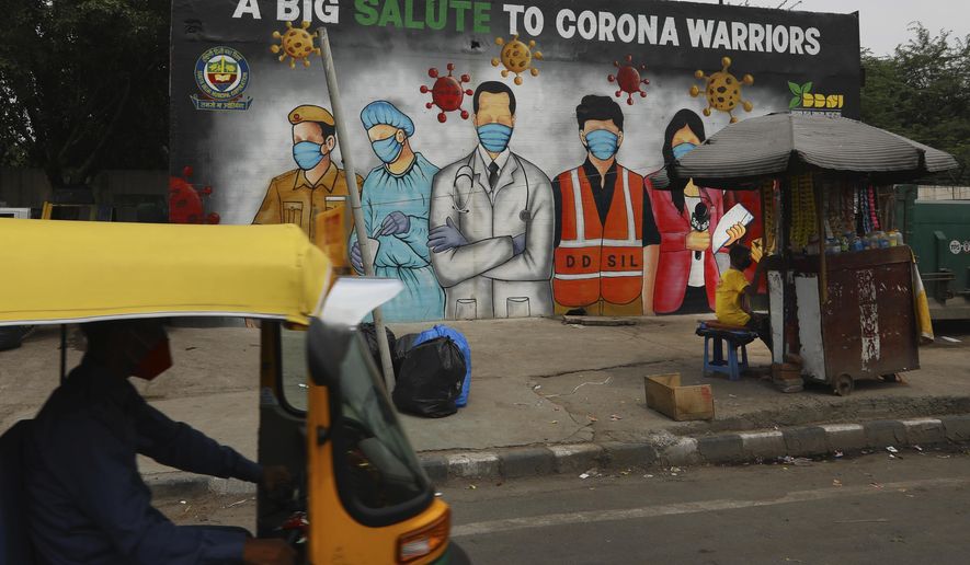 An autorickshaw drives past a graffiti thanking frontline workers in the fight against the coronavirus, in New Delhi, India, Wednesday, July 1, 2020. Indian Prime Minister Narendra Modi said in a live address Tuesday that the country&#x27;s coronavirus death rate is under control, but that the country is at a “critical juncture.” Since the lockdown was lifted, the caseload has shot up, making India the world&#x27;s fourth-worst affected country. (AP Photo/Manish Swarup)