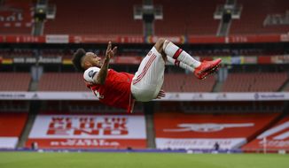 Arsenal&#39;s Pierre-Emerick Aubameyang celebrates after scoring his side third goal Bduring the English Premier League soccer match between Arsenal and Norwich City at the Emirates Stadium in London, England, Wednesday, July 1, 2020. (Richard Heathcote/Pool via AP)