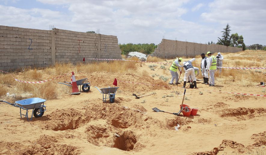 Libyan Ministry of justice employees dig out at a siyte of a suspected mass grave in the town of Tarhouna, Libya, Tuesday, June 23, 2020. The United Nations said that at least eight mass graves have been discovered, mostly in Tarhuna, a key western town that served as a main stronghold for Khalifa&#39;s east-based forces in their 14-month campaign to capture the capital, Tripoli. (AP Photo/Hazem Ahmed)