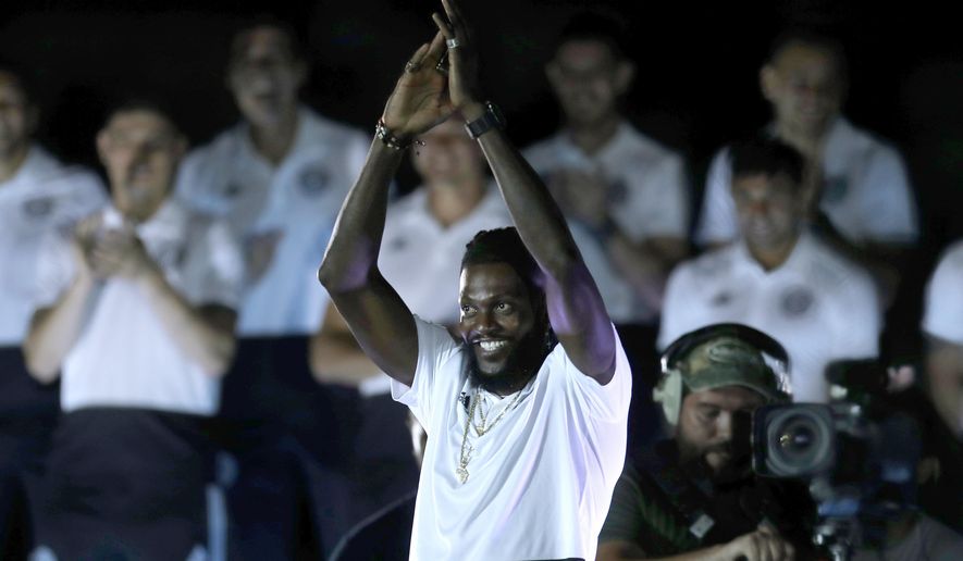 Togo striker Emmanuel Adebayor smiles during his presentation as the newest member of Paraguay's Olimpia soccer team, at the Manuel Ferreira stadium in Asuncion, Paraguay, Friday, Feb. 14, 2020. (AP Photo/Jorge Saenz)