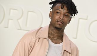 In this Feb. 7, 2020 file photo, 21 Savage attends the Tom Ford show during NYFW Fall/Winter in Los Angeles. The rapper will be launching a free online financial literacy education program for youth sheltered at home during the coronavirus pandemic. The Grammy winner announced his new Bank Account At Home nationwide initiative on Wednesday. His efforts will include a partnership with Atlanta mayor Keisha Lance Bottoms to provide free Wi-Fi and tablets for underserved inner-city students. (Photo by Jordan Strauss/Invision/AP)