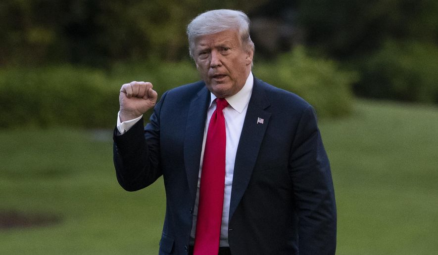 President Donald Trump pumps his fist as he walks on the South Lawn after arriving on Marine One at the White House, Thursday, June 25, 2020, in Washington. Trump is returning from Wisconsin. (AP Photo/Alex Brandon)