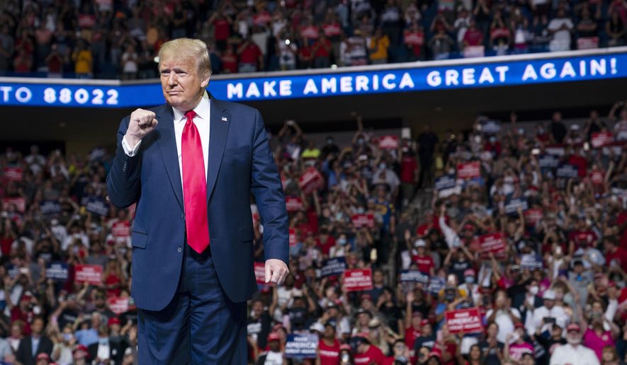 President Donald Trump arrives on stage to speak at a campaign rally at the BOK Center, Saturday, June 20, 2020, in Tulsa, Okla.  Trump is asking Americans to let him keep his job. His critics are asking how much of that job he’s actually doing. Those questions have gotten louder in recent days following revelations that Trump didn’t read at least two written intelligence briefings detailing concerns that Russia was paying bounties to the Taliban for the deaths of Americans in Afghanistan. (AP Photo/Evan Vucci)