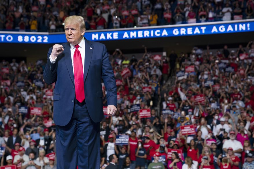 President Donald Trump arrives on stage to speak at a campaign rally at the BOK Center, Saturday, June 20, 2020, in Tulsa, Okla.  Trump is asking Americans to let him keep his job. His critics are asking how much of that job he’s actually doing. Those questions have gotten louder in recent days following revelations that Trump didn’t read at least two written intelligence briefings detailing concerns that Russia was paying bounties to the Taliban for the deaths of Americans in Afghanistan. (AP Photo/Evan Vucci)