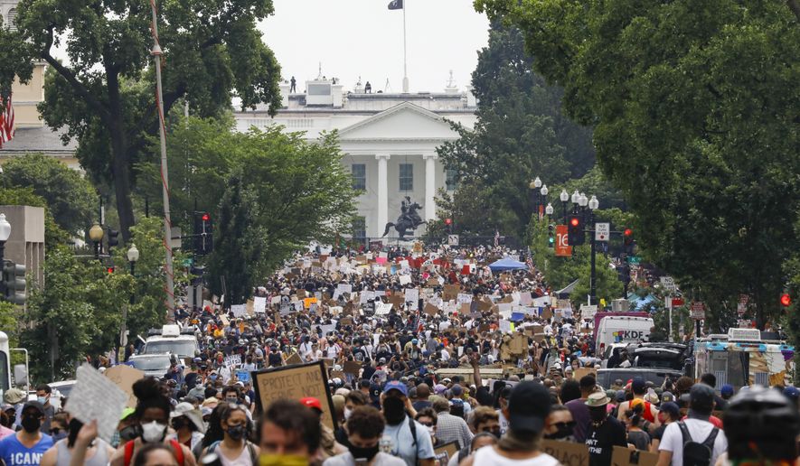FILE - In this Saturday, June 6, 2020 file photo, demonstrators gather near the White House in Washington, to protest the death of George Floyd, a black man who was in police custody in Minneapolis. Public health experts say there is little evidence that the protests that erupted after Floyd’s death caused a significant increase in coronavirus infections. If the protests had driven an explosion in cases, experts say, the jumps would have started to become apparent within two weeks — and perhaps as early as five days. (AP Photo/Jacquelyn Martin)