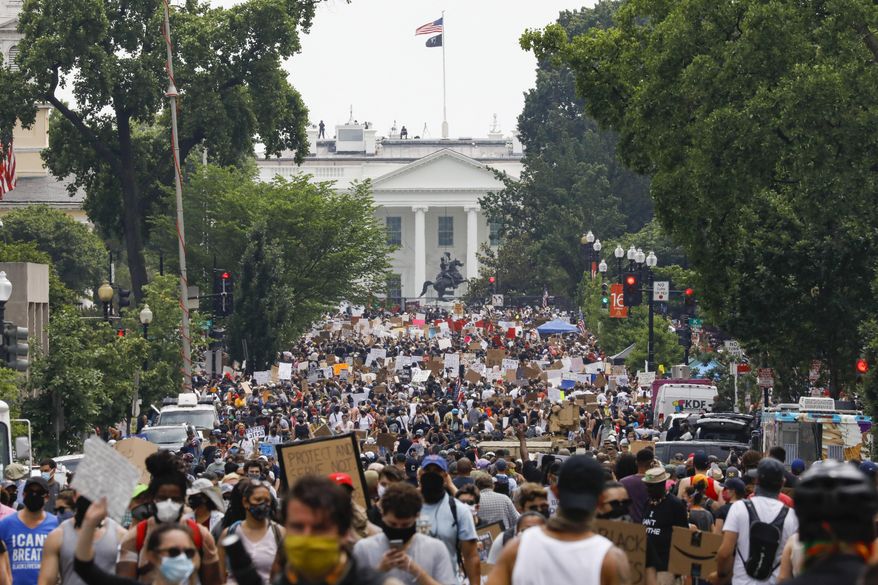 FILE - In this Saturday, June 6, 2020 file photo, demonstrators gather near the White House in Washington, to protest the death of George Floyd, a black man who was in police custody in Minneapolis. Public health experts say there is little evidence that the protests that erupted after Floyd’s death caused a significant increase in coronavirus infections. If the protests had driven an explosion in cases, experts say, the jumps would have started to become apparent within two weeks — and perhaps as early as five days. (AP Photo/Jacquelyn Martin)