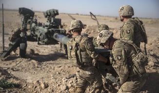 In this June 10, 2017, file photo provided by Operation Resolute Support, U.S. soldiers with Task Force Iron maneuver an M-777 howitzer, so it can be towed into position at Bost Airfield, Afghanistan. Moscow and Washington are intertwined in a complex and bloody history in Afghanistan, with both suffering thousands of dead and wounded in conflicts lasting for years. Now both superpowers are linked again over Afghanistan, with intelligence reports indicating Russia secretly offered bounties to the Taliban to kill American troops there. (U.S. Marine Corps photo by Sgt. Justin T. Updegraff, Operation Resolute Support via AP, File)