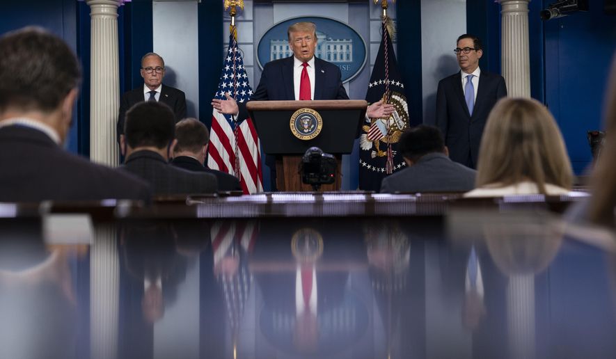 President Donald Trump speaks during a news briefing at the White House, Thursday, July 2, 2020, in Washington, as White House chief economic adviser Larry Kudlow, left, and Treasury Secretary Steven Mnuchin, look on. (AP Photo/Evan Vucci)