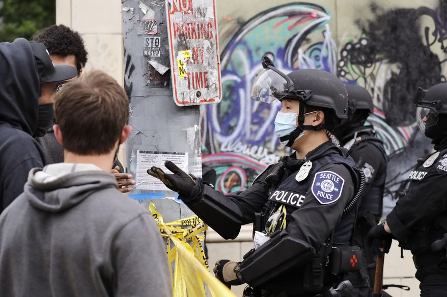 A police officer engages with a protester Wednesday, July 1, 2020, in Seattle, where streets had been blocked off in an area demonstrators had occupied for weeks. Seattle police showed up in force earlier in the day at the &amp;quot;occupied&amp;quot; protest zone, tore down demonstrators&#39; tents and used bicycles to herd the protesters after the mayor ordered the area cleared following two fatal shootings in less than two weeks. The &amp;quot;Capitol Hill Occupied Protest&amp;quot; zone was set up near downtown following the death of George Floyd while in police custody in Minneapolis. (AP Photo/Elaine Thompson)