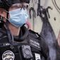 Seattle police officer Terry Whalen, a member of the department's hostage negotiating team, wears a patch reading "Stop screaming, I'm scared too" while standing with other officers blocking an intersection Wednesday, July 1, 2020, in Seattle, where streets had been blocked off in an area demonstrators had occupied for weeks. Whalen says that the patch, a gift to him, helps calm interactions with people who may be upset. Seattle police showed up in force earlier in the day at the "occupied" protest zone, tore down demonstrators' tents and used bicycles to herd the protesters after the mayor ordered the area cleared following two fatal shootings in less than two weeks. The "Capitol Hill Occupied Protest" zone was set up near downtown following the death of George Floyd while in police custody in Minneapolis. (AP Photo/Elaine Thompson)