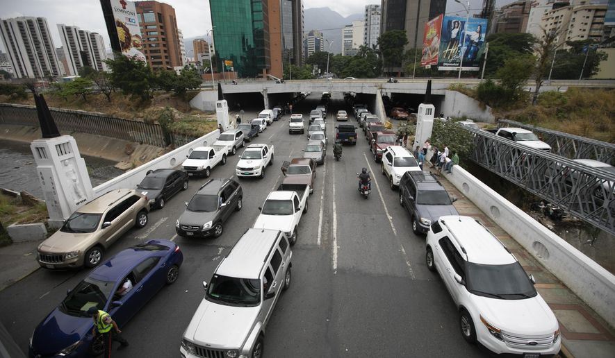 Vehicles line up near a gas station to fill their tanks, in Caracas, Venezuela, Friday, May 29, 2020. Venezuela boasts the world&#39;s largest underground oil reserves, but it has been forced to buy fuel from Iran to bridge deep shortages, unable to pump crude from the ground and turn it into gasoline. (AP Photo/Ariana Cubillos)