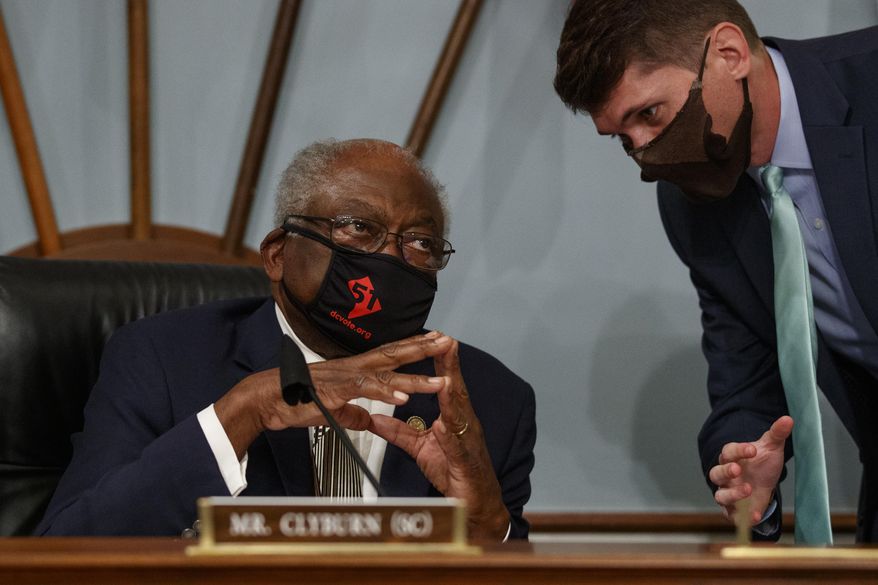 Select Subcommittee on the Coronavirus Crisis chairman Rep. James Clyburn, D-S.C., left, speaks with an aid Capitol Hill in Washington, Friday, June 26, 2020, before a hearing with Gene L. Dodaro, Comptroller General of the United States, about a new report from the U.S. Government Accountability Office (GAO) with recommendations to improve the federal coronavirus response. (AP Photo/Carolyn Kaster)