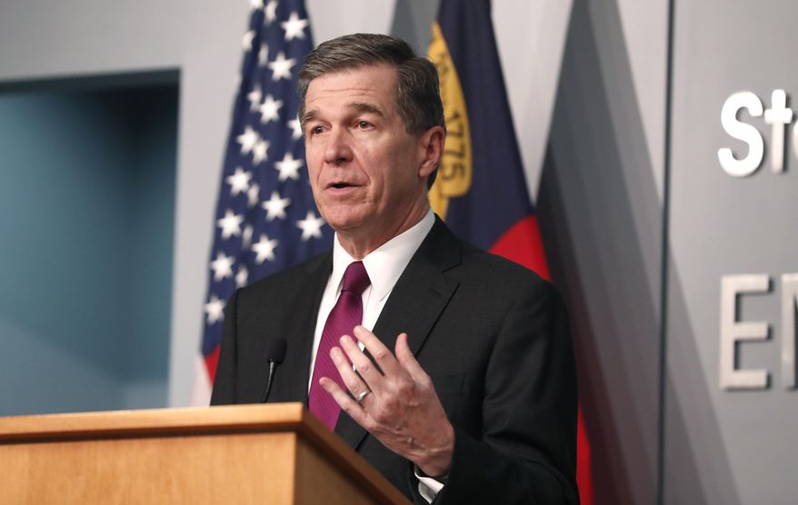 Gov. Roy Cooper answers a question during a briefing at the Emergency Operations Center in Raleigh, N.C., Wednesday, July 1, 2020.  (Ethan Hyman/The News &amp;amp; Observer via AP)