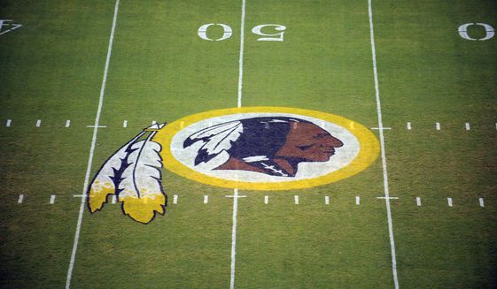 In this Aug. 28, 2009 file photo, the Washington Redskins logo is shown on the field before the start of a preseason NFL football game against the New England Patriots in Landover, Md. The Washington Redskins are undergoing what the team calls a thorough review of the nickname. In a statement released Friday, July 3, 2020, the team says it has been talking to the NFL for weeks about the subject. Owner Dan Snyder says the process will include input from alumni, sponsors, the league, community and members of the organization. FedEx on Thursday called for the team to change its name, and Nike appeared to remove all Redskins gear from its online store. (AP Photo/Nick Wass) ** FILE **
