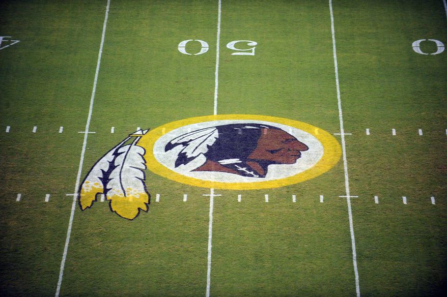 FILE - In this Aug. 28, 2009 file photo, the Washington Redskins logo is shown on the field before the start of a preseason NFL football game against the New England Patriots in Landover, Md. The Washington Redskins are undergoing what the team calls a “thorough review” of the nickname. In a statement released Friday, July 3, 2020, the team says it has been talking to the NFL for weeks about the subject. Owner Dan Snyder says the process will include input from alumni, sponsors, the league, community and members of the organization. FedEx on Thursday called for the team to change its name, and Nike appeared to remove all Redskins gear from its online store. (AP Photo/Nick Wass, File)