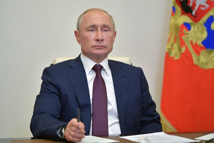 Russian President Vladimir Putin chairs a meeting with members of working group to prepare proposals on amending the Russian Constitution via teleconference in Moscow, Russia, Friday, July 3, 2020. Almost 78% of voters in Russia have approved amendments to the country's constitution that will allow President Vladimir Putin to stay in power until 2036, Russian election officials said Thursday after all the votes were counted. Kremlin critics said the vote was rigged. (Alexei Druzhinin, Sputnik, Kremlin Pool Photo via AP)