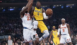 FILER - In this Feb. 21, 2020, file photo, Indiana Pacers guard Victor Oladipo (4) goes to the basket against New York Knicks center Mitchell Robinson (23) in the first half of an NBA basketball game at Madison Square Garden in New York. The Pacers will finish this season without Oladipo after the two-time All-Star decided to sit out because of the risk of re-injuring his right knee. (AP Photo/Mary Altaffer)