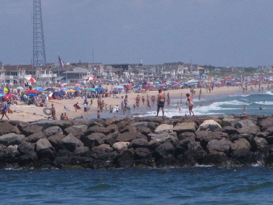 A large crowd fills the beach in Manasquan, N.J. on June 28, 2020. With large crowds expected at the Jersey Shore for the July Fourth weekend, some are worried that a failure to heed mask-wearing and social distancing protocols could accelerate the spread of the coronavirus. (AP Photo/Wayne Parry)
