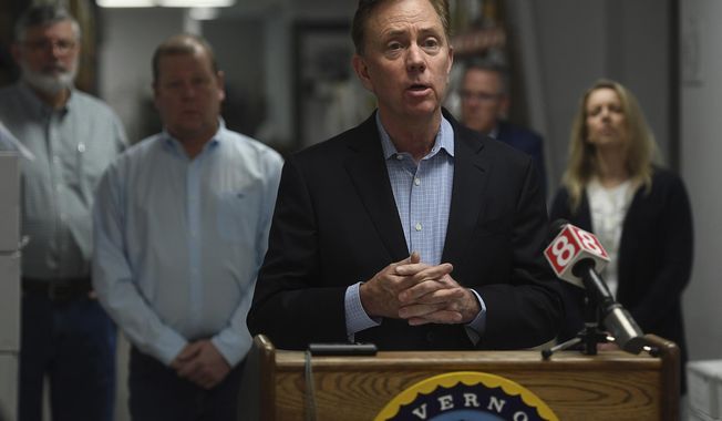 FILE - In this March 29, 2020, file photo, Connecticut Gov. Ned Lamont addresses the media at medical equipment manufacturer Bio-Med Devices in Guilford, Conn. On Thursday, July 2, 2020, Lamont announced a change to the required 14-day quarantine for visitors from states with high COVID-19 infection rates. He believes the quarantine announced the week before by Connecticut, New Jersey and New York has limited the number of Connecticut&#x27;s out-of-state visitors. (Brian A. Pounds/Hearst Connecticut Media via AP, File)