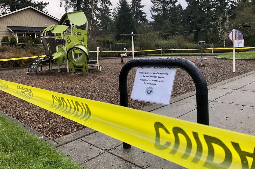 FILE - In this March 24, 2020, file photo, police caution tape surrounds a playground in Lake Oswego, Ore., during the coronavirus outbreak. Oregon health officials reported its second-highest tally of confirmed cases of COVID-19 and five additional deaths on Friday, June 26, 2020, the same day that authorities released new modeling that shows increased transmission of the coronavirus since the state began reopening in mid-May. (AP Photo/Gillian Flaccus, File)