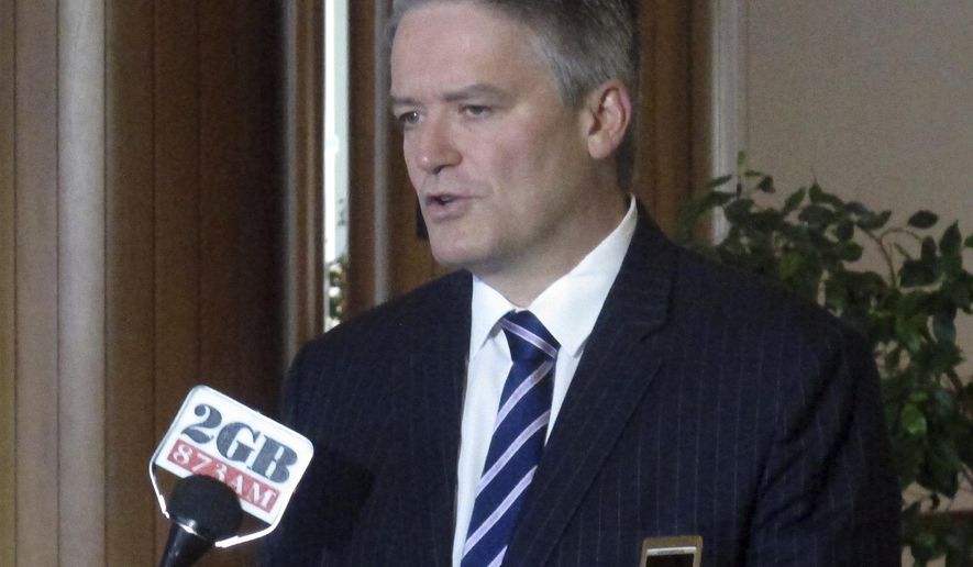 FILE - In this Aug. 8, 2017, file photo, Australian Finance Minister Mathias Cormann addresses reporters at Parliament House in Canberra, Australia. Cormann, one of Prime Minister Scott Morrison’s most senior Cabinet members, said Sunday, July 5, 2020 he is retiring from politics at the end of the year. Belgium-born Cormann, who has been finance minister since 2013, entered federal politics in 2007 and became the leader government’s Senate, or upper house, leader in 2017. (AP Photo/Rod McGuirk, File)