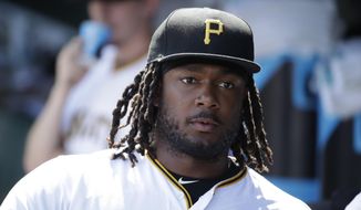 FILE - In this  Saturday, June 22, 2019 file photo, Pittsburgh Pirates&#39; Josh Bell waits to take the field for the team&#39;s baseball game against the San Diego Padres in Pittsburgh. Pirates first baseman Josh Bell watched George Floyd&#39;s death in horror. Rarely one to talk, Bell prefers to have his actions speak for him. Bell, who is Black, has started a book club and a weekly &amp;quot;Social Reform Sunday&amp;quot; movement on Instagram where he attempts to highlight one of the may issues surrounding the fight for racial (AP Photo/Gene J. Puskar, File)