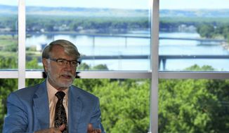 Larry Skogen talks on June 26, 2020 about his time as president of Bismarck State College Friday, June 26, 2020 with a panoramic view of the Missouri River in the background from the National Energy Center of Excellence building in Bismarck, North Dakota. Skogen will retire as the sixth president after serving since 2007.   (Mike McCleary/The Bismarck Tribune via AP)