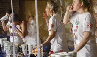 Competitive eater Miki Sudo, second right, eats a women&#39;s world record of 48 and a half hot dogs to win the women&#39;s division of the Nathan&#39;s Famous July Fourth hot dog eating contest, Saturday, July 4, 2020, in the Brooklyn borough of New York. (AP Photo/John Minchillo)