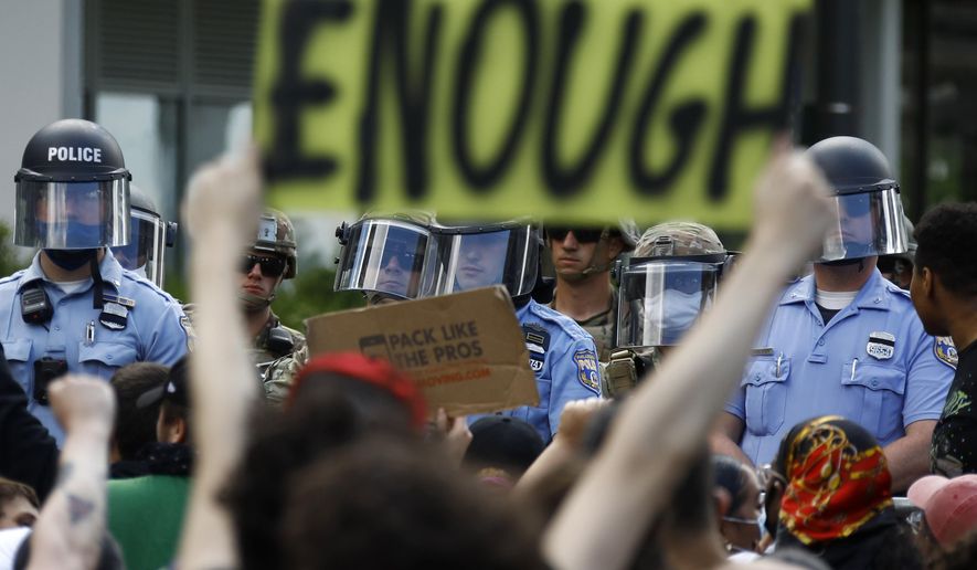 FILE - In this June 1, 2020, file photo, protesters rally as Philadelphia Police officers and Pennsylvania National Guard soldiers look on in Philadelphia, over the death of George Floyd, a black man who was in police custody in Minneapolis. (AP Photo/Matt Slocum, File)