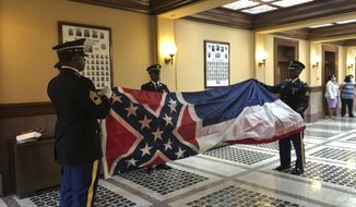 Honor guard members from the Mississippi National Guard practice folding the former Mississippi flag before a ceremony to retire the banner on Wednesday, July 1, 2020, inside the state Capitol in Jackson. The ceremony happened a day after Republican Gov. Tate Reeves signed a law that removed the flag&#39;s official status as a state symbol. The 126-year-old banner was the last state flag in the U.S. with the Confederate battle emblem. (AP Photo/Emily Wagster Pettus)